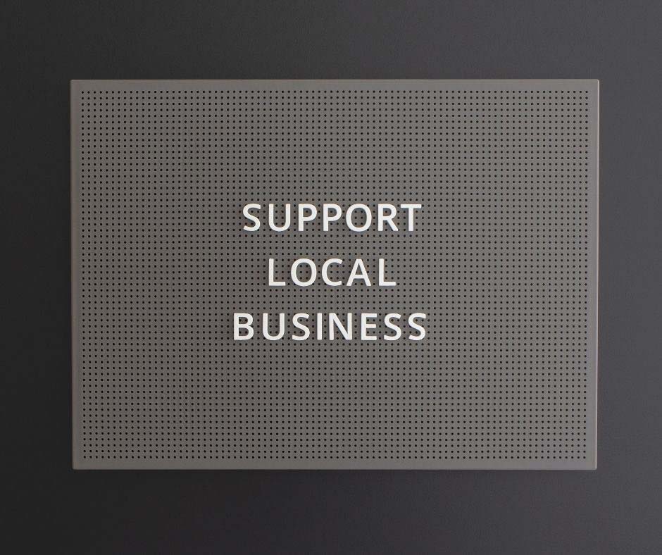 Nástenka s nápisom Support local business